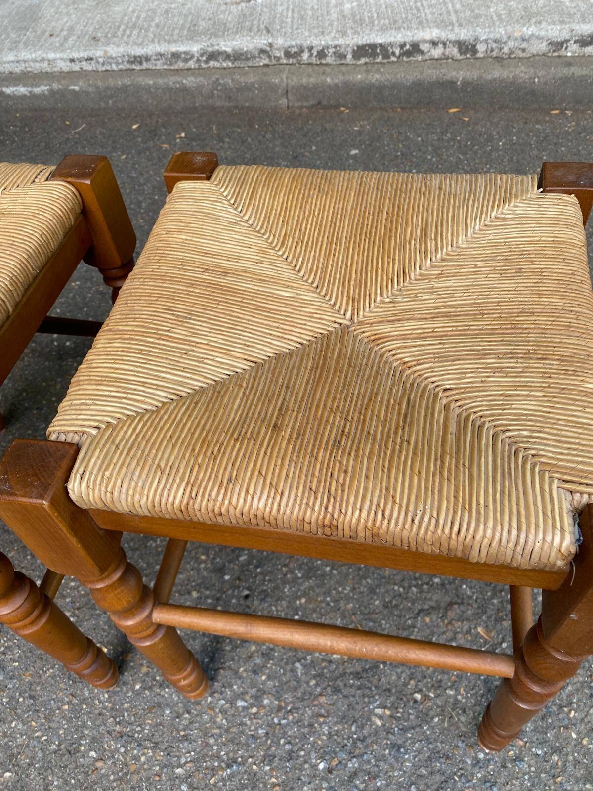 2 square stools made of carved solid wood with rush seats from the 1970s.