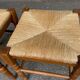 2 square stools made of carved solid wood with rush seats from the 1970s.