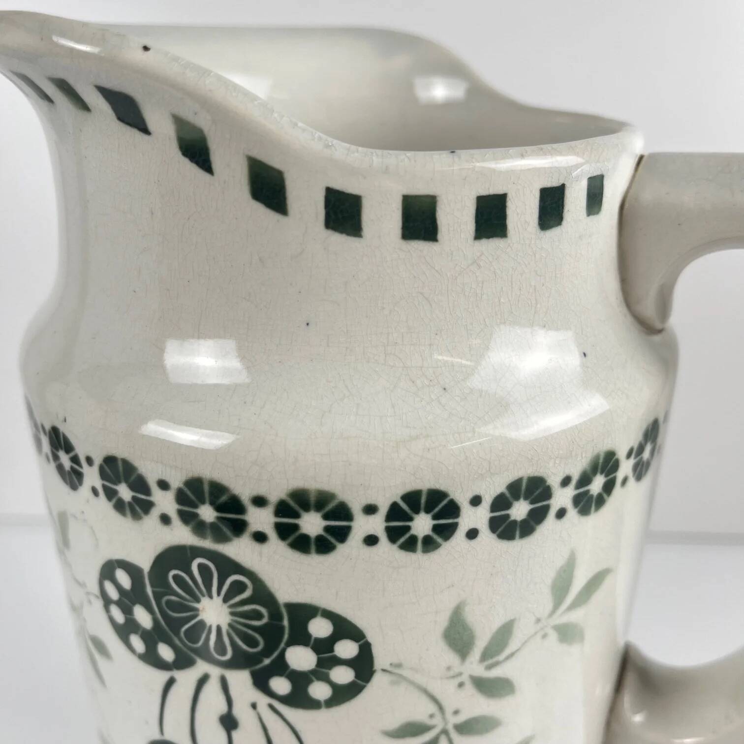 Antique earthenware pitcher, green floral decoration, fine ironstone from the late 19th to early 20th century.