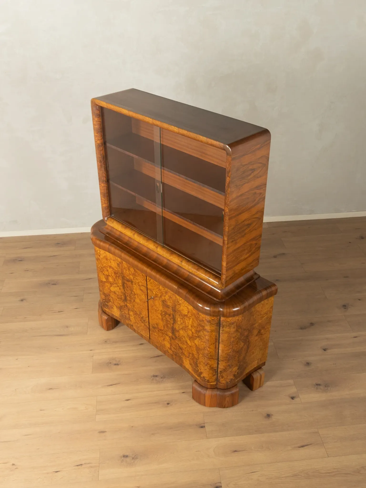 Classic two-piece Art Deco display cabinet from the 1930s with striking burl wood veneer