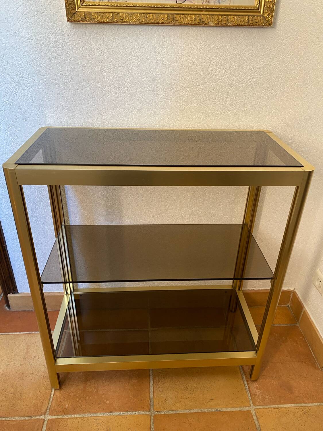 Regency style console table, in gilded metal and smoked glass