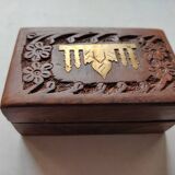 Old wooden box carved with flowers and brass