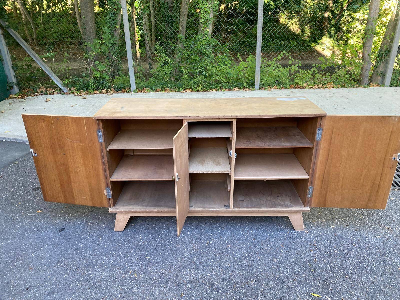 Vintage 1950s oak enfilade buffet with tapered legs.
