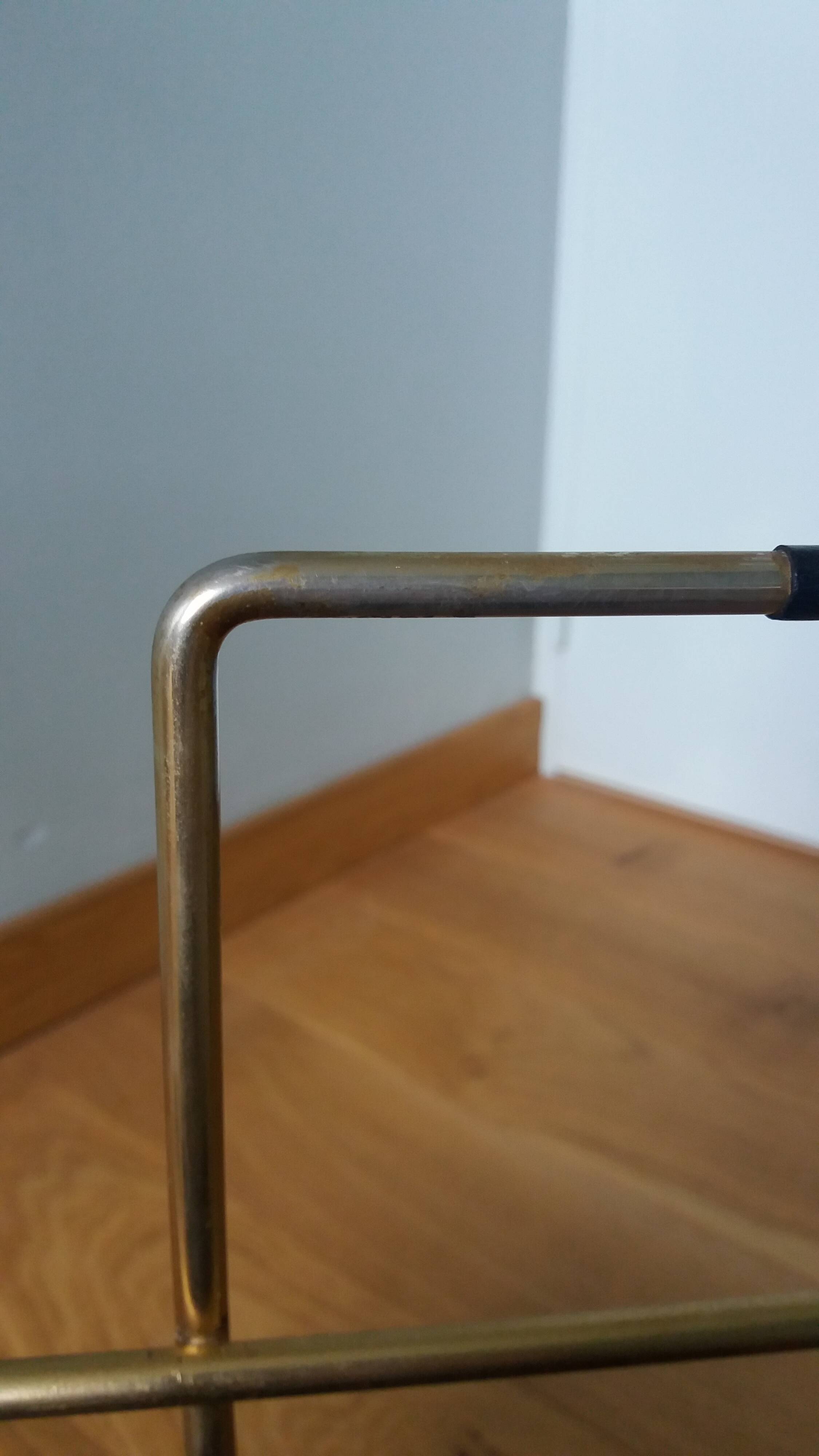 Modernist magazine rack in the style of Jacques Adnet