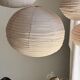 Average suspension in natural rattan and linen, Japanese-style, flattened oval in pink.