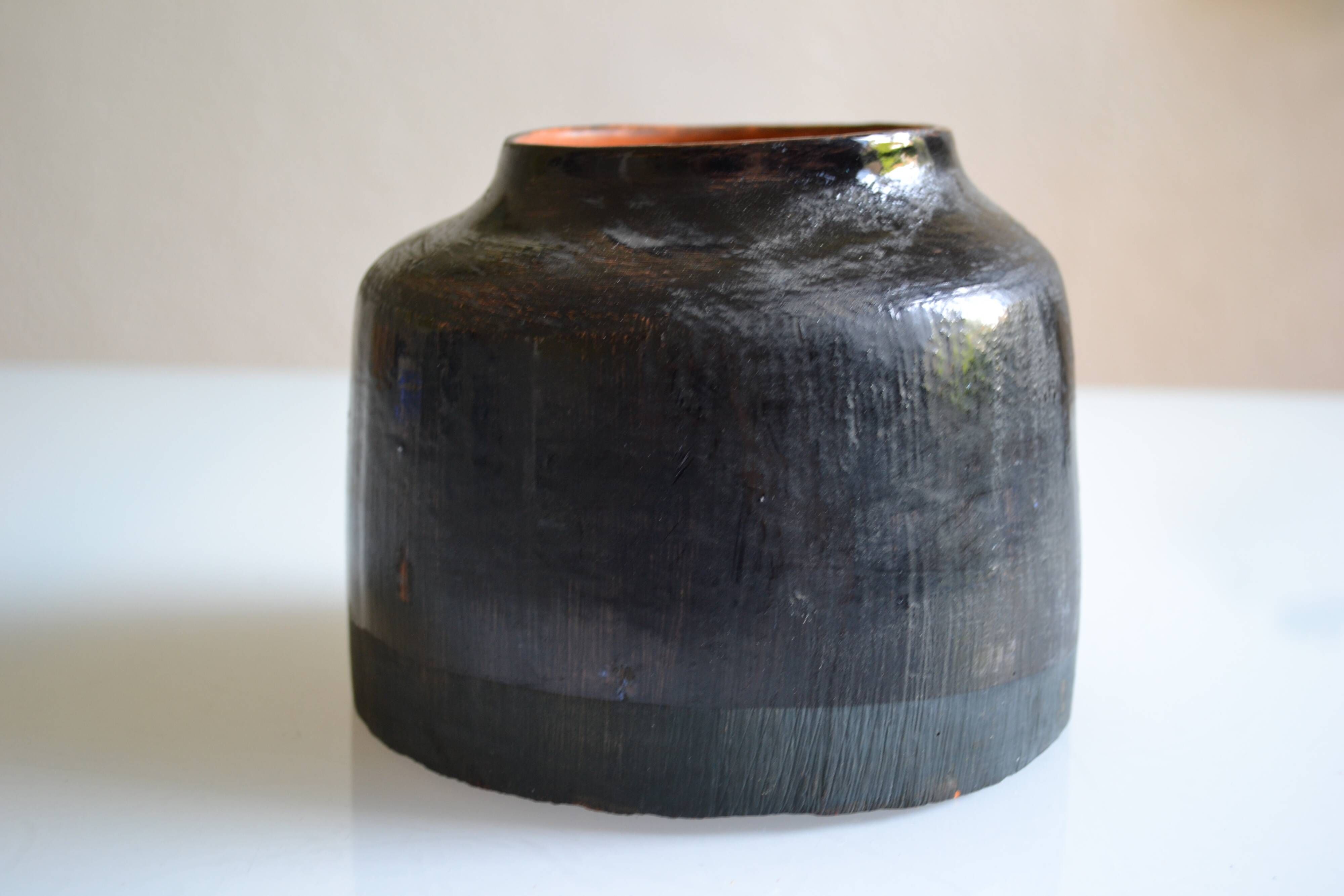 Ceramic vase with a signature fish to identify.
