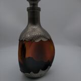 Vintage decanter in glass and tin.
