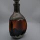 Vintage decanter in glass and tin.