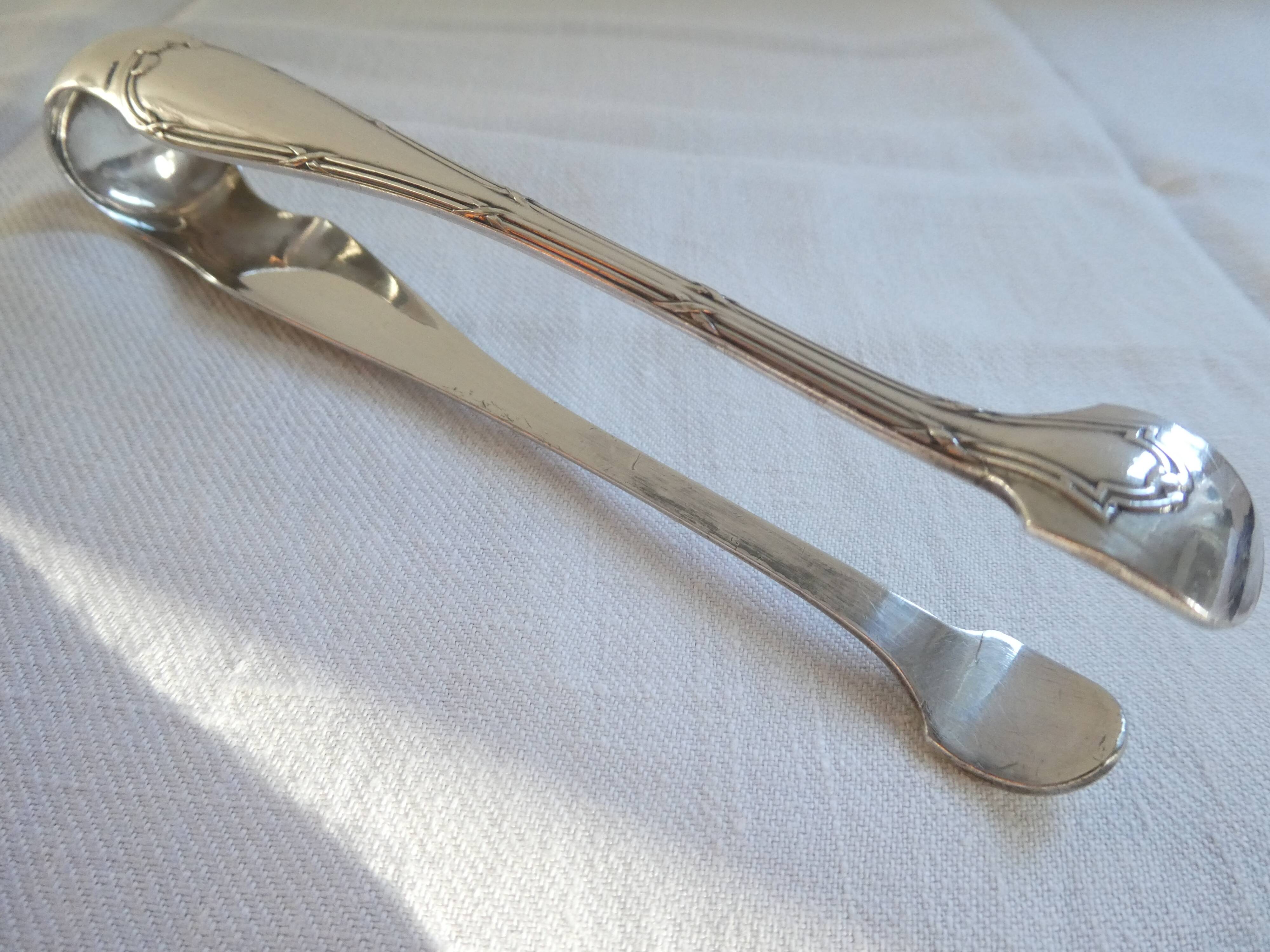 Christofle Silver-plated metal sugar tongs with crossed ribbon bow design