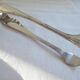 Christofle Silver-plated metal sugar tongs with crossed ribbon bow design