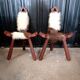 Pair of brutalist tripod chairs in wood and cowhide