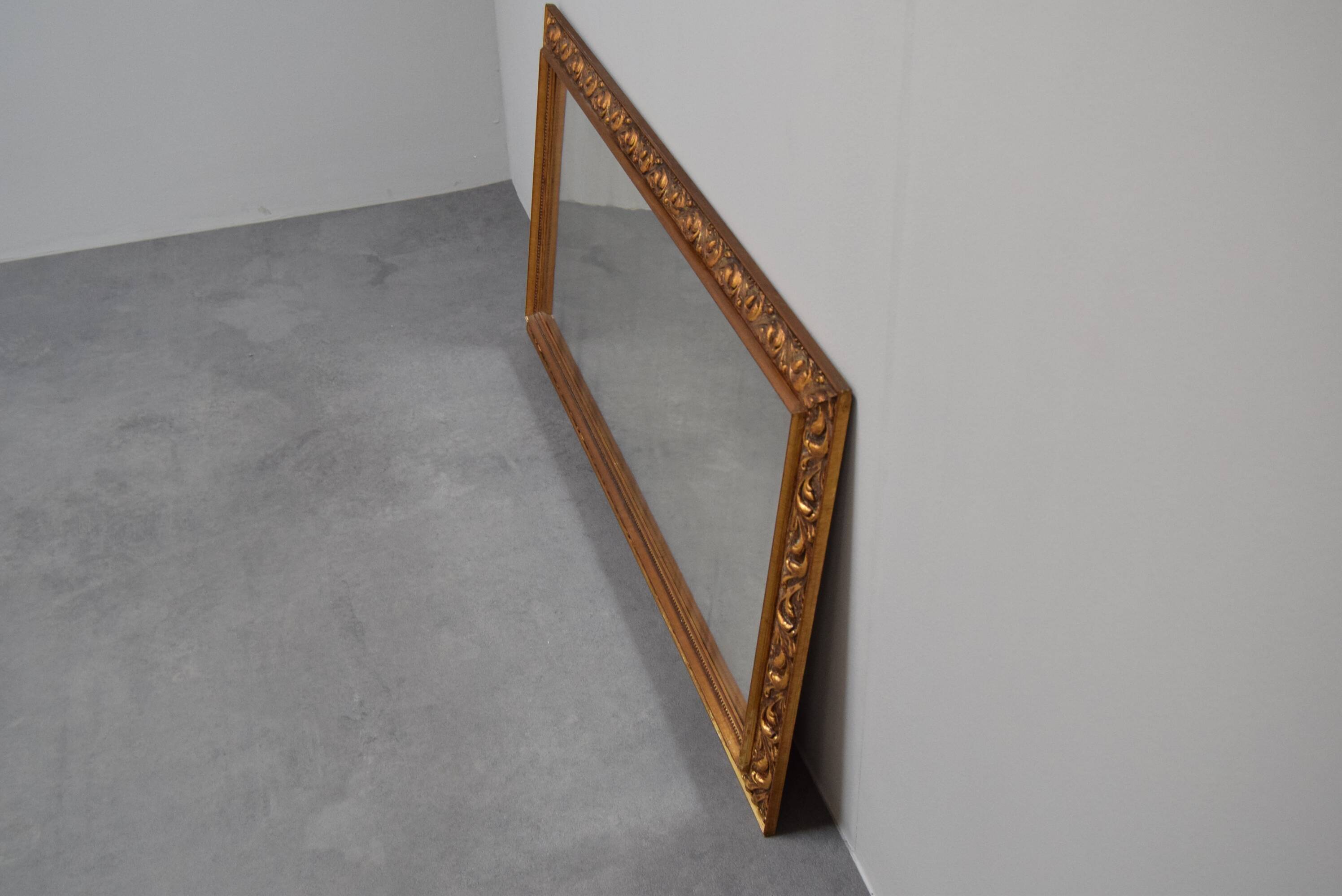 wall mirror in a decorative wooden frame.