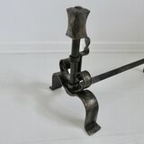 Pair of ironwork andirons in the style of Raymond Subes, circa 1940