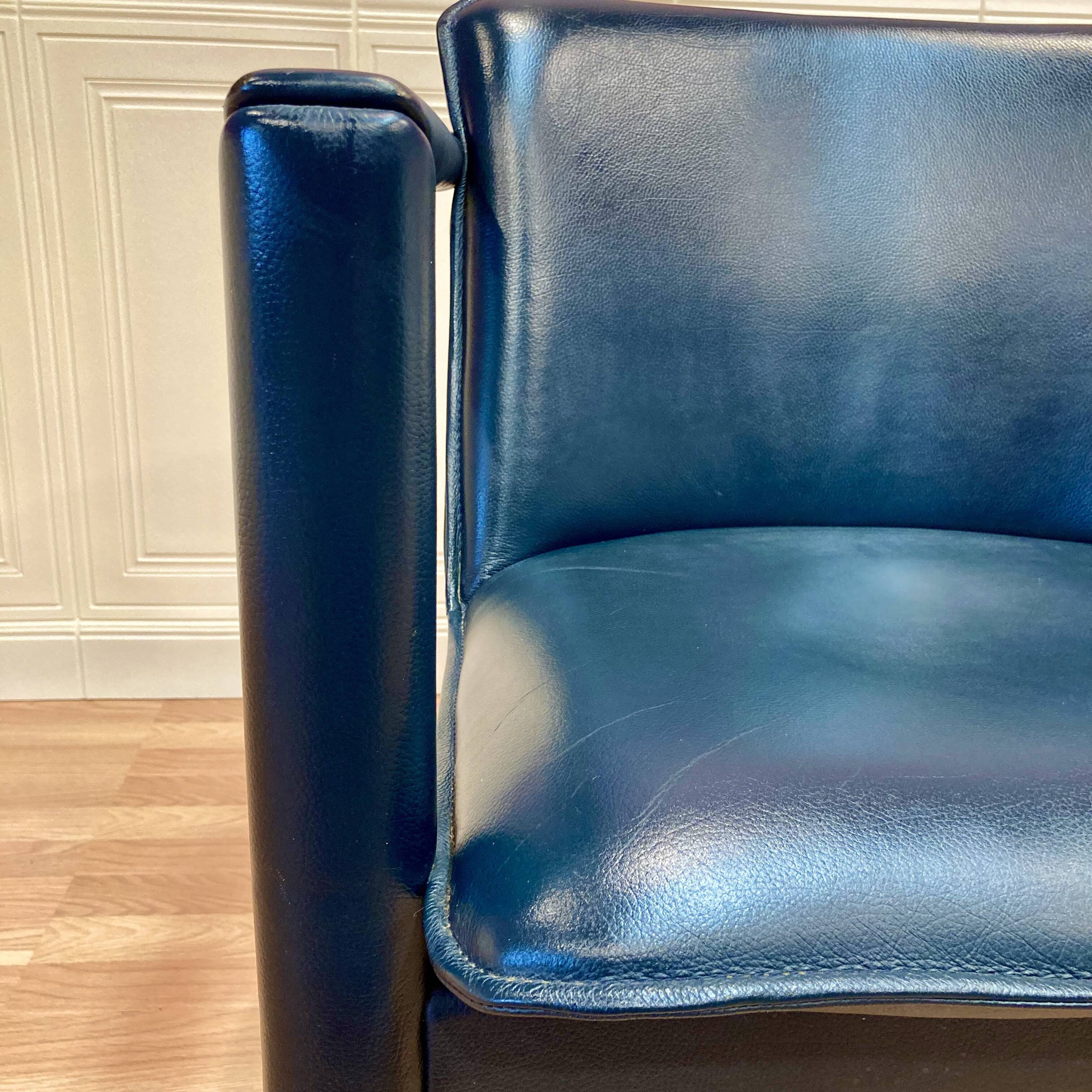 Set of 3 designer leather and metal armchairs.