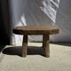 Small stool, oval solid teak side table with curved legs in wabi-sabi style.