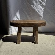 Small stool, oval solid teak side table with curved legs in wabi-sabi style.
