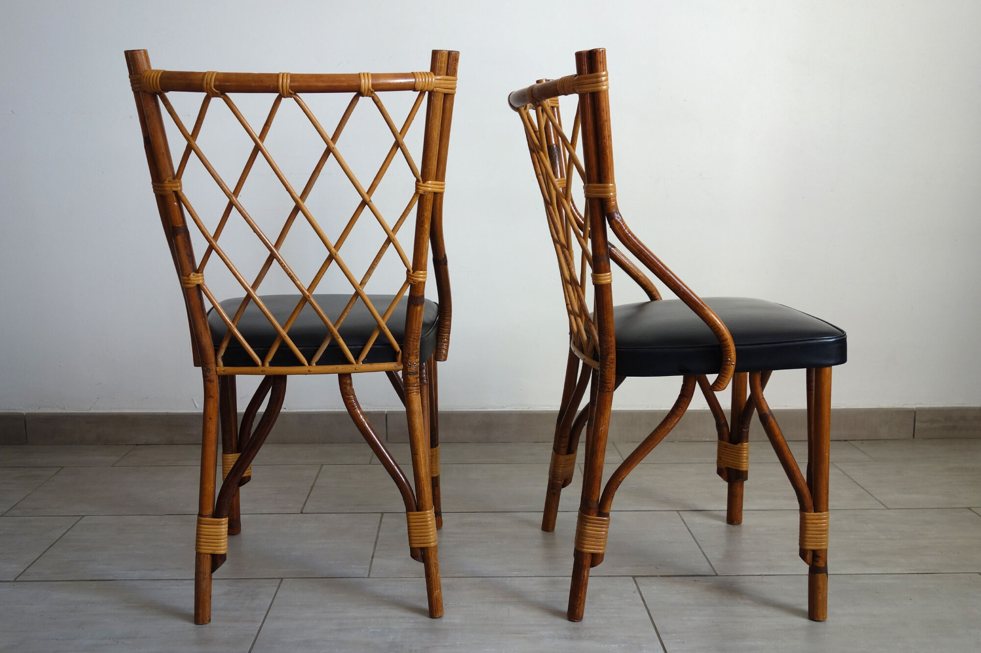 Pair of rattan and black skai bamboo chairs, 60s