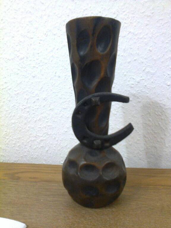 Carved turned wooden vase for dry flowers, decorated with a small horseshoe