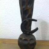 Carved turned wooden vase for dry flowers, decorated with a small horseshoe