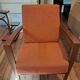 Vintage Art Deco armchair in curved wood and terracotta fabric.
