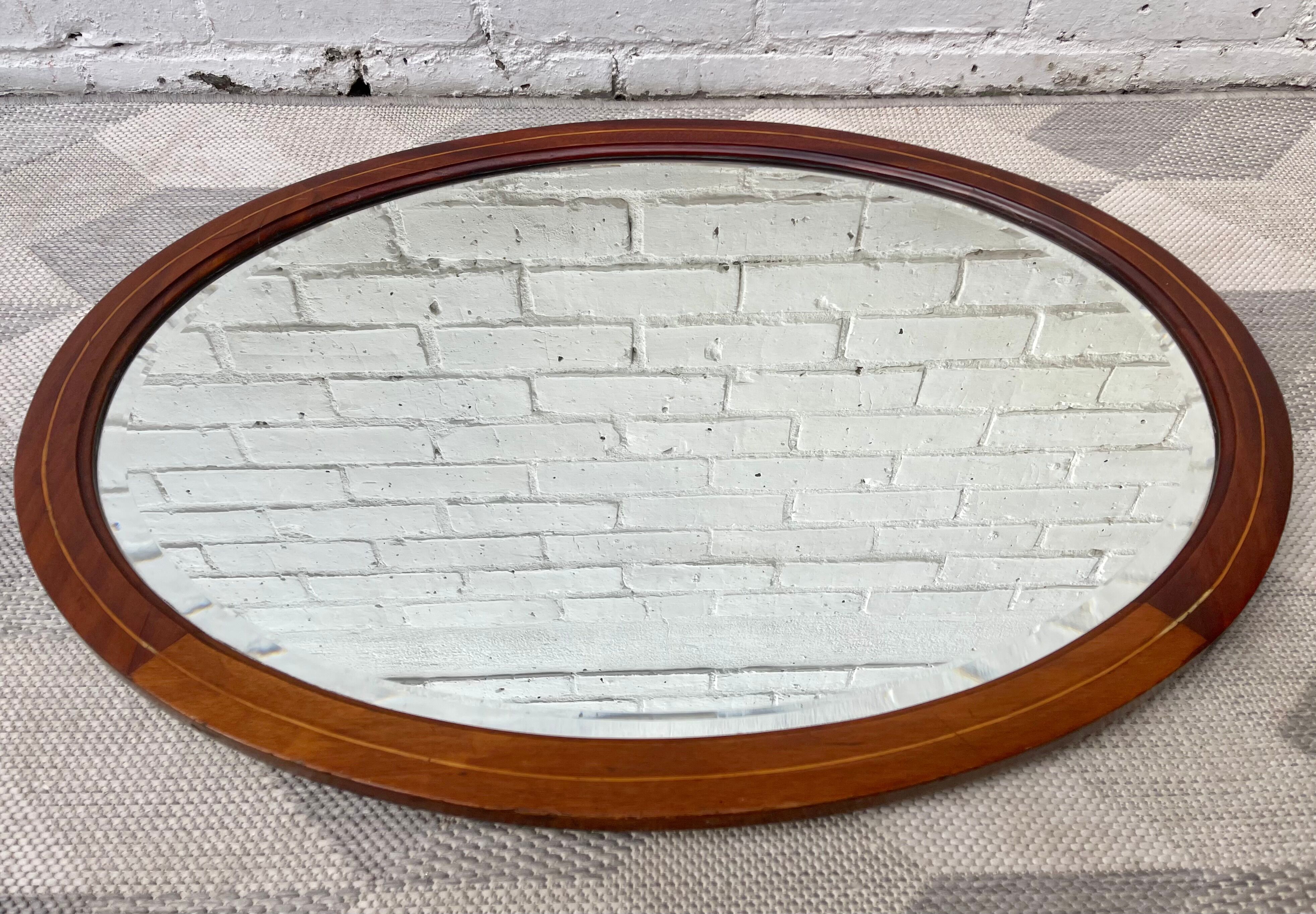 Vintage oval bevelled mirror mahogany frame