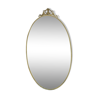 Oval mirror in gilded bronze 84x48 cm