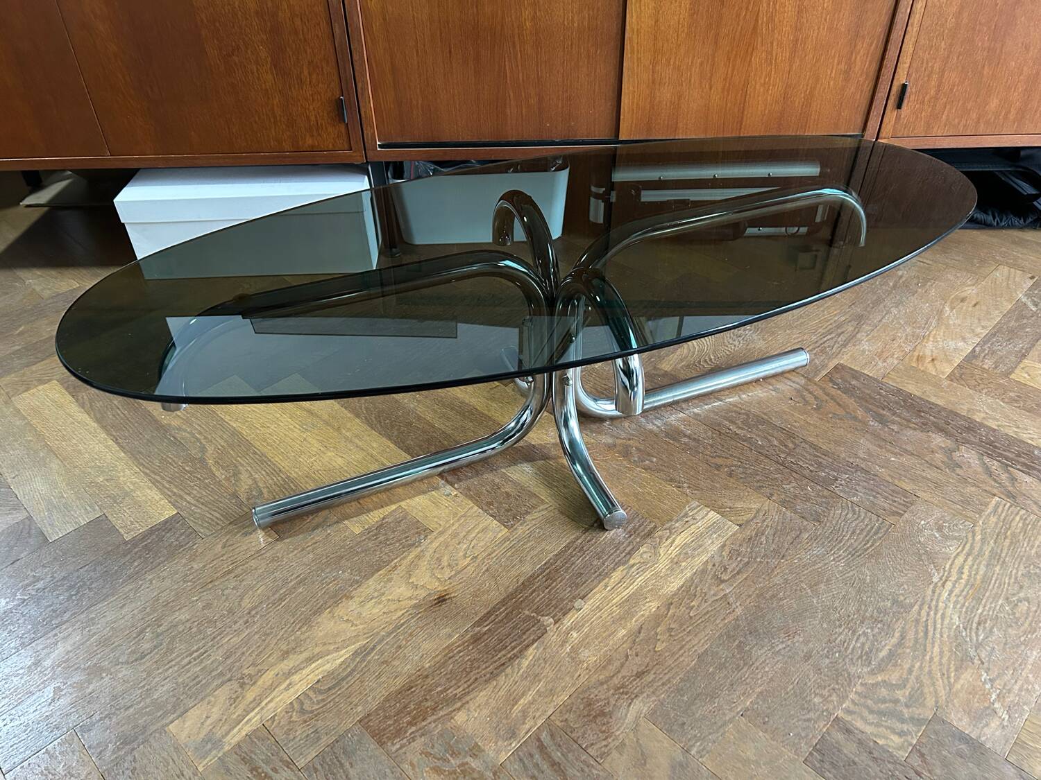 70s design oval coffee table in smoked black glass with chrome legs.
