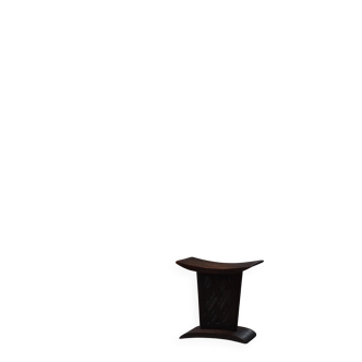 Sculptural African stool in hardwood, curved seat and architectural base, 1970s.