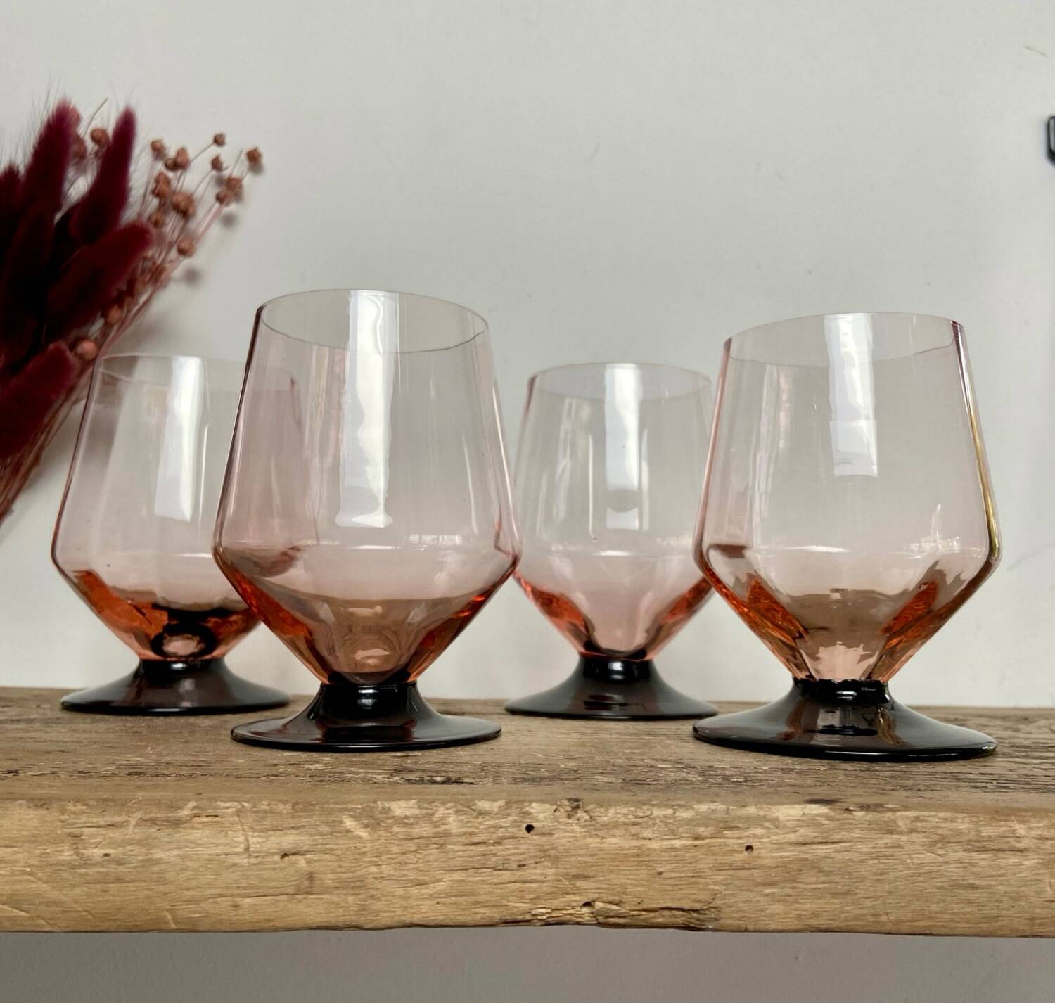 4 pink glasses with black stems