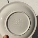 4 black speckled dessert plates on a vintage white background