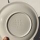 4 black speckled dessert plates on a vintage white background