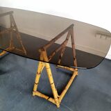 1970s dining table with bamboo trestle legs and smoked glass