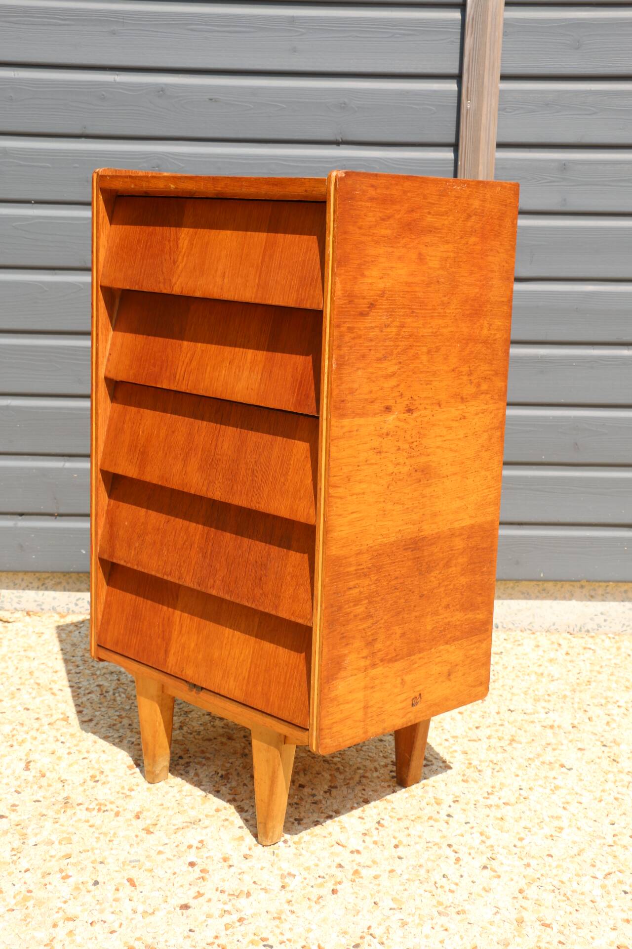 Dark chest of drawers with 5 drawers from the 1950s