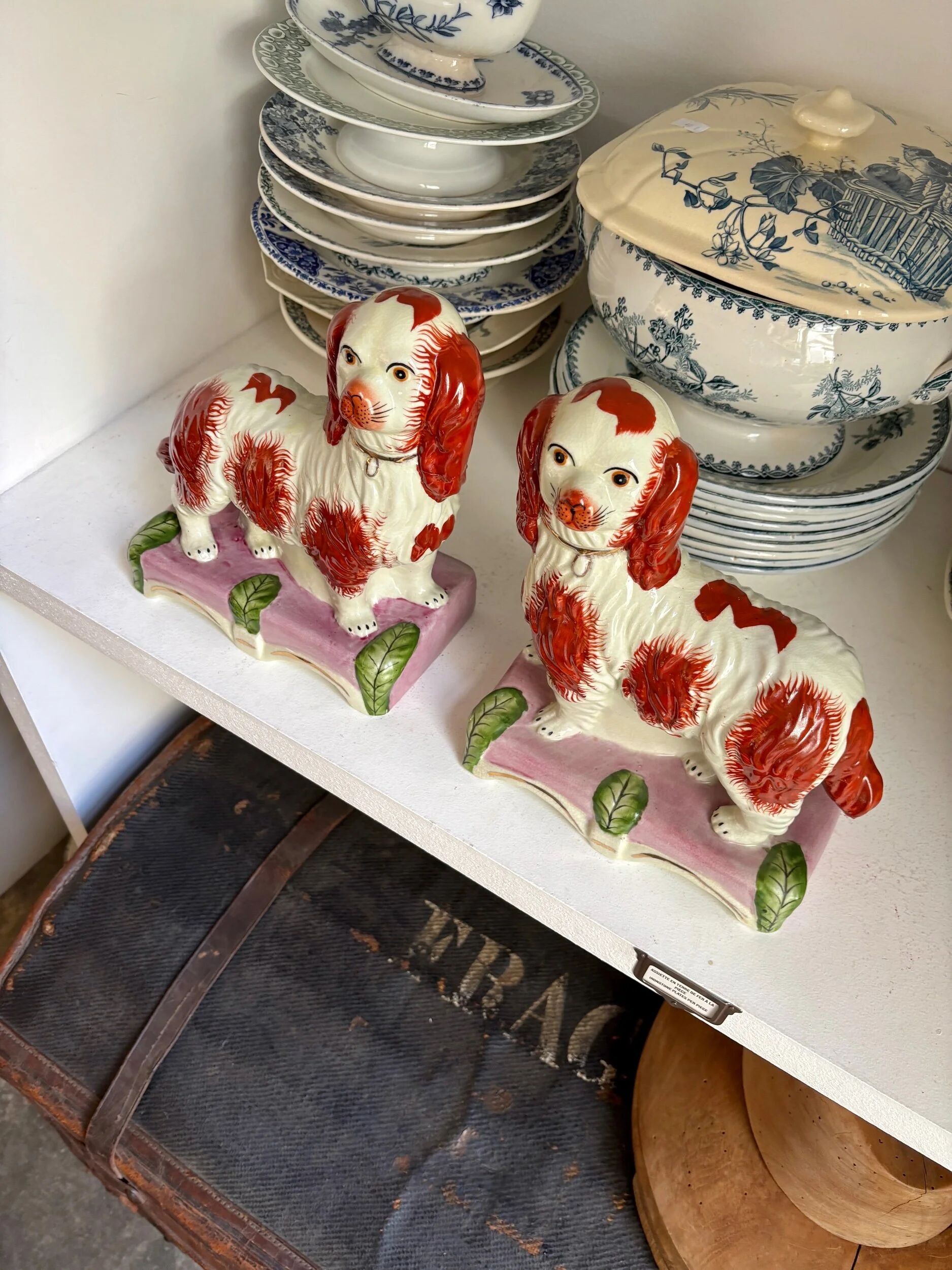Pair of Staffordshire porcelain Cavalier King Charles dogs on terrace, 19th century.