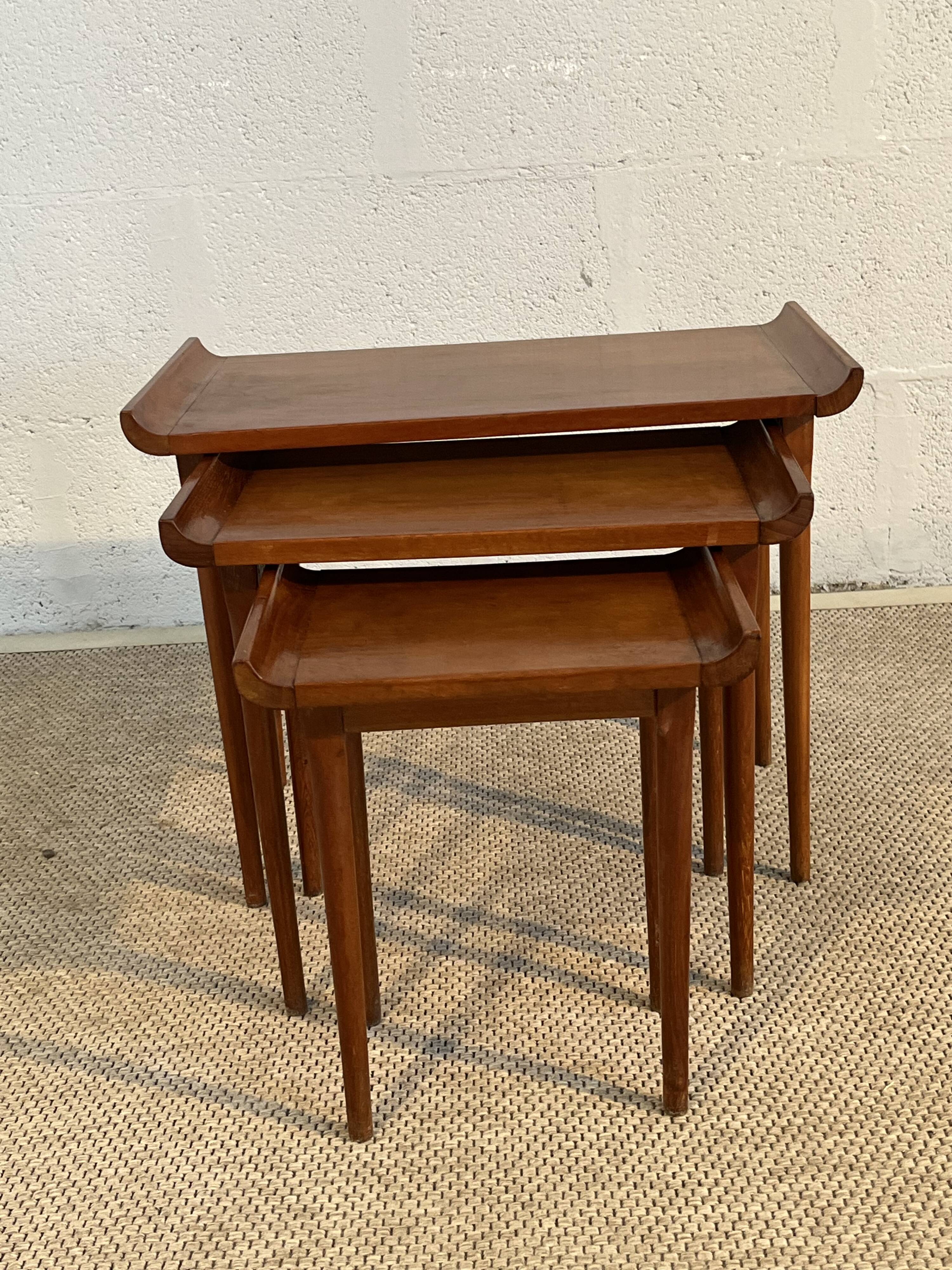 Set of three nesting low tables in a Japanese style, made of mahogany.
