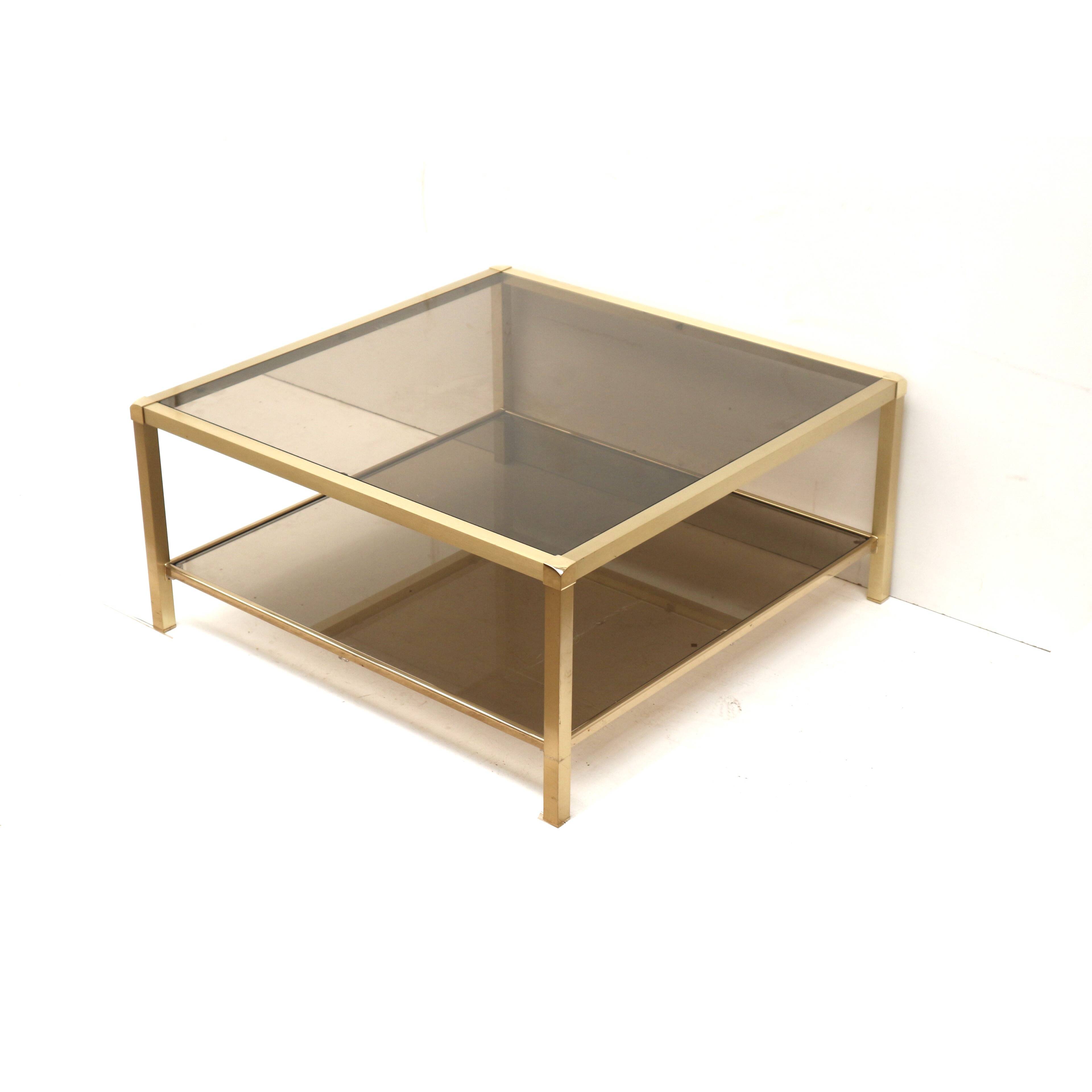 Large vintage Hollywood Regency coffee table made of brass and smoked glass from the 1970s