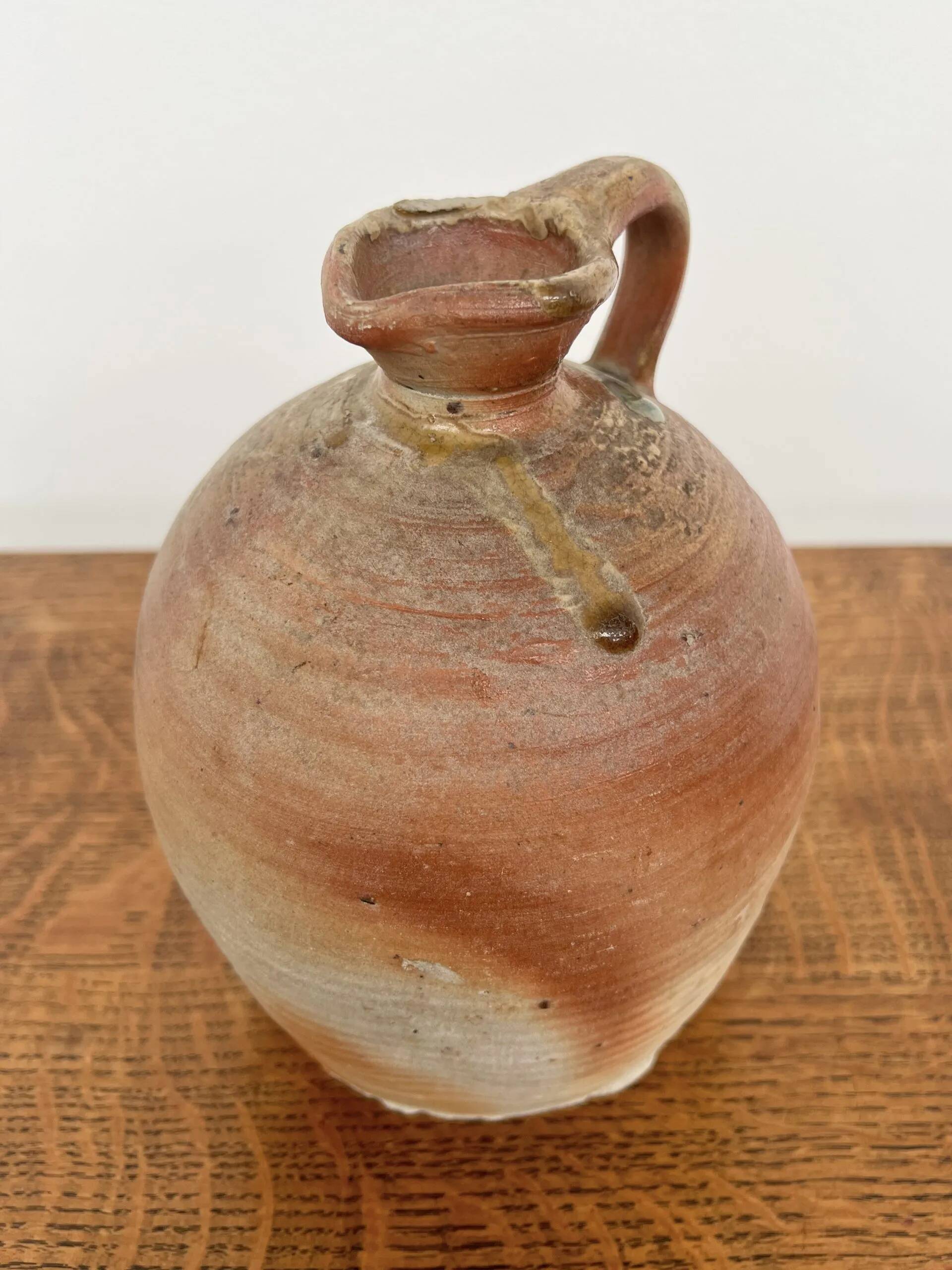 Small antique stoneware jar with handle
