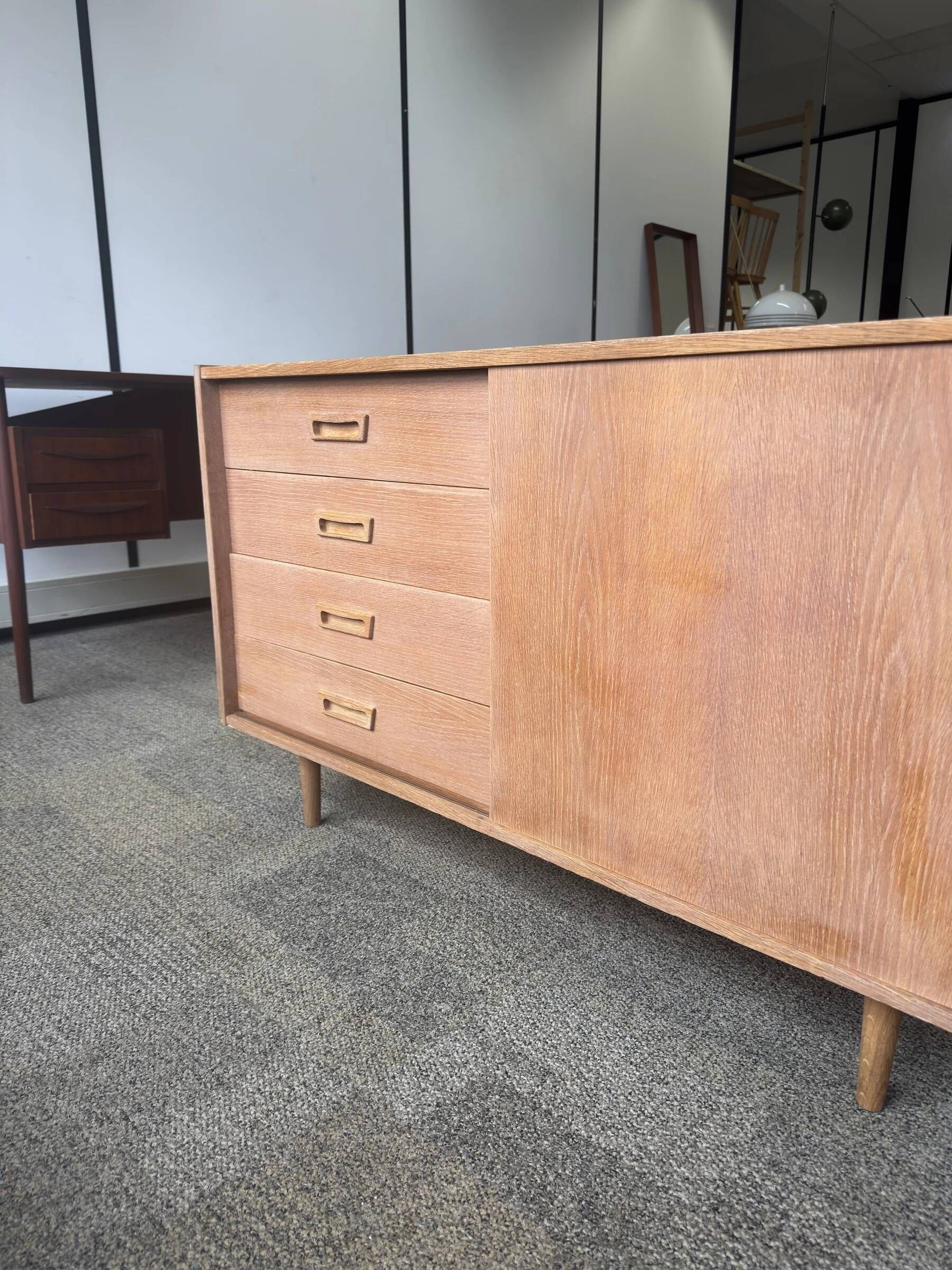 Danish buffet in light oak with sliding door and four drawers.