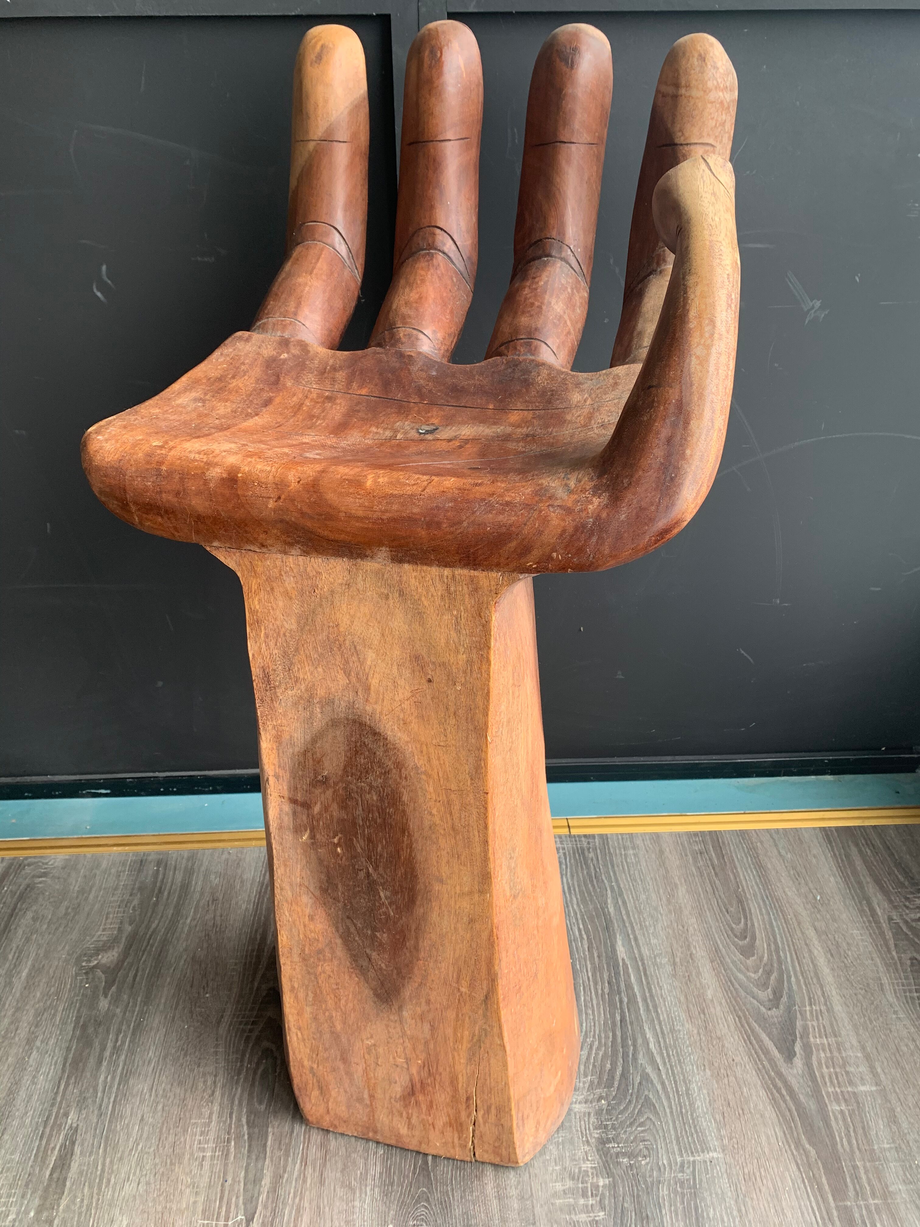 Hand-shaped carved wooden stool