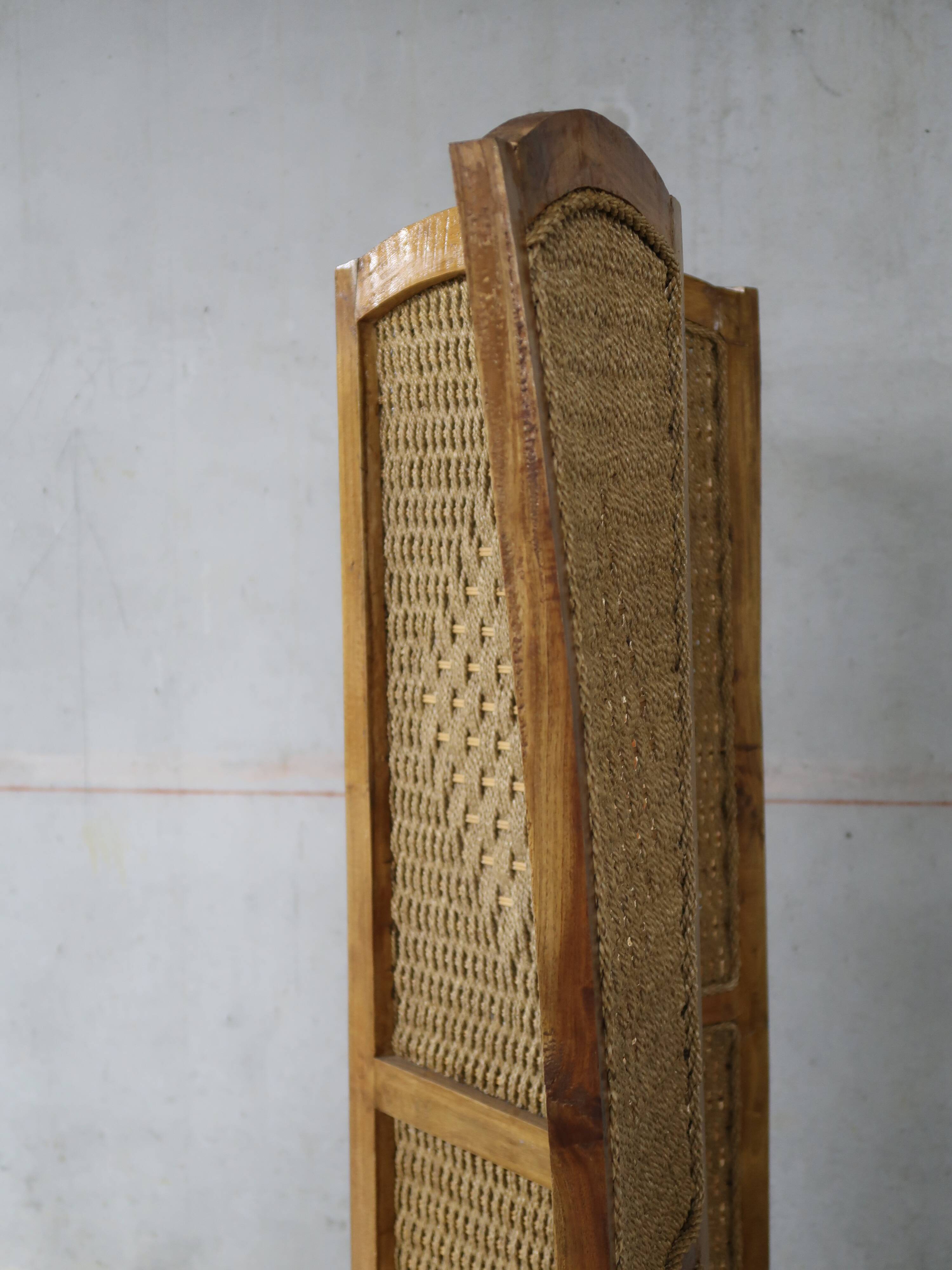 Handcrafted screen in exotic wood and rope.