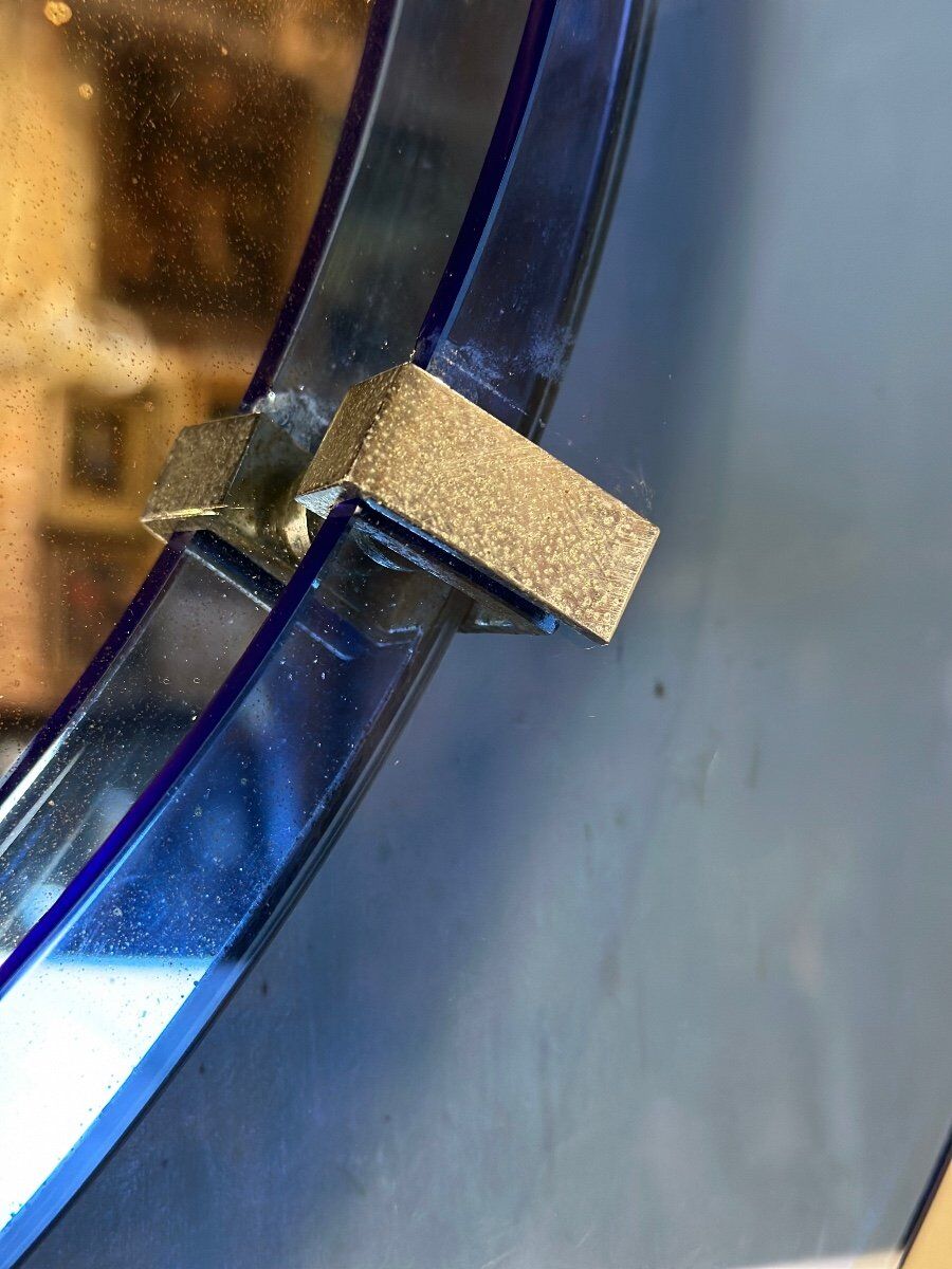 Mirror framed by a blue glass circle, italy circa 1950