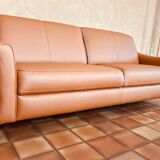 Cognac-colored leather sofa, new condition, never used due to death