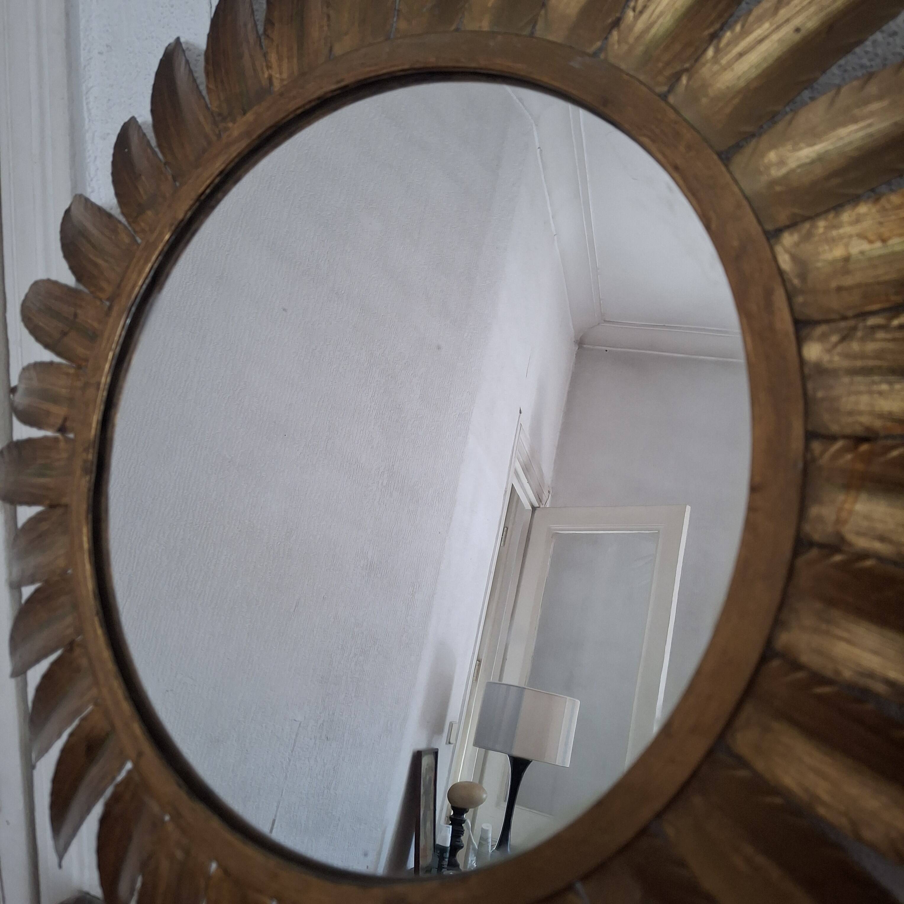 Large sun mirror in gilded metal. 1960