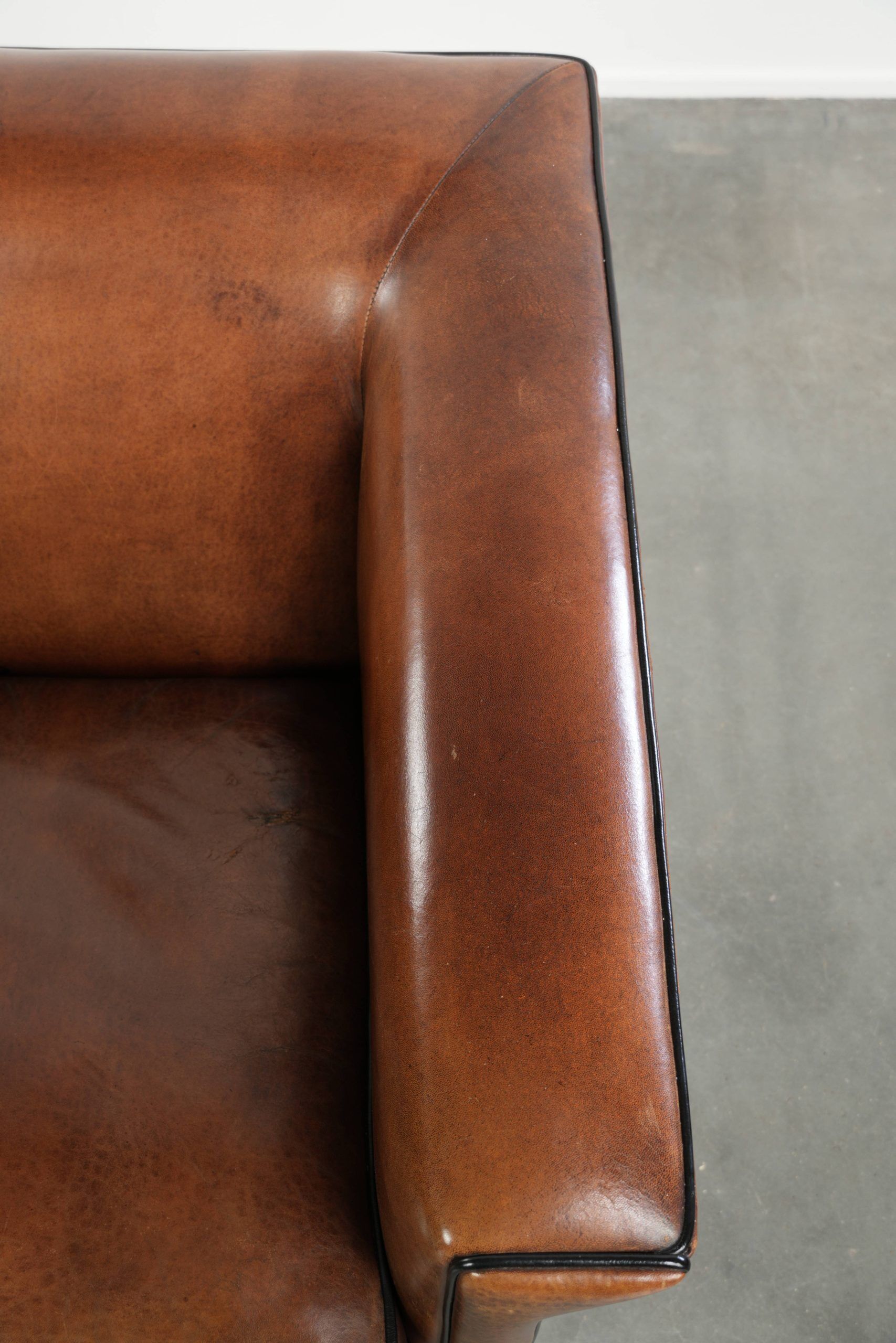 Sleek sheepskin Art Deco design armchair with black piping