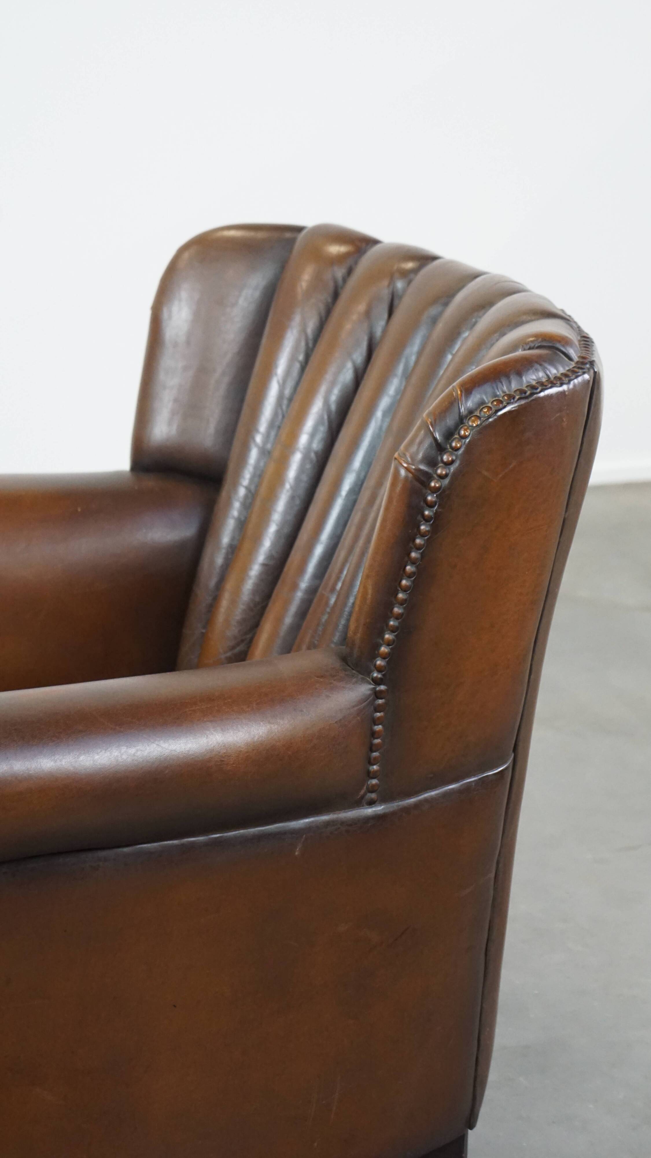 Sheep leather armchair finished with decorative nails