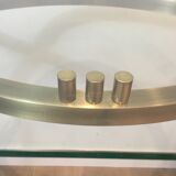 Console en acier brossé et laiton et plateau formé d'une dalle de verre. Travail français. Vers 1970