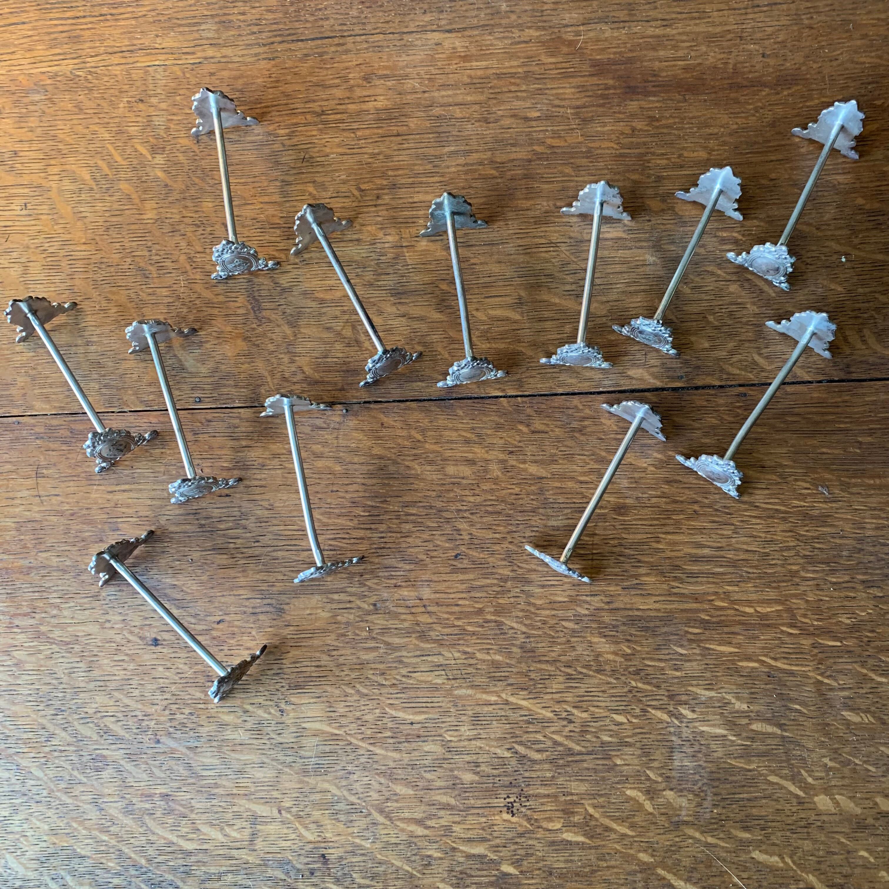 Series of 12 monogrammed silver metal knife holders