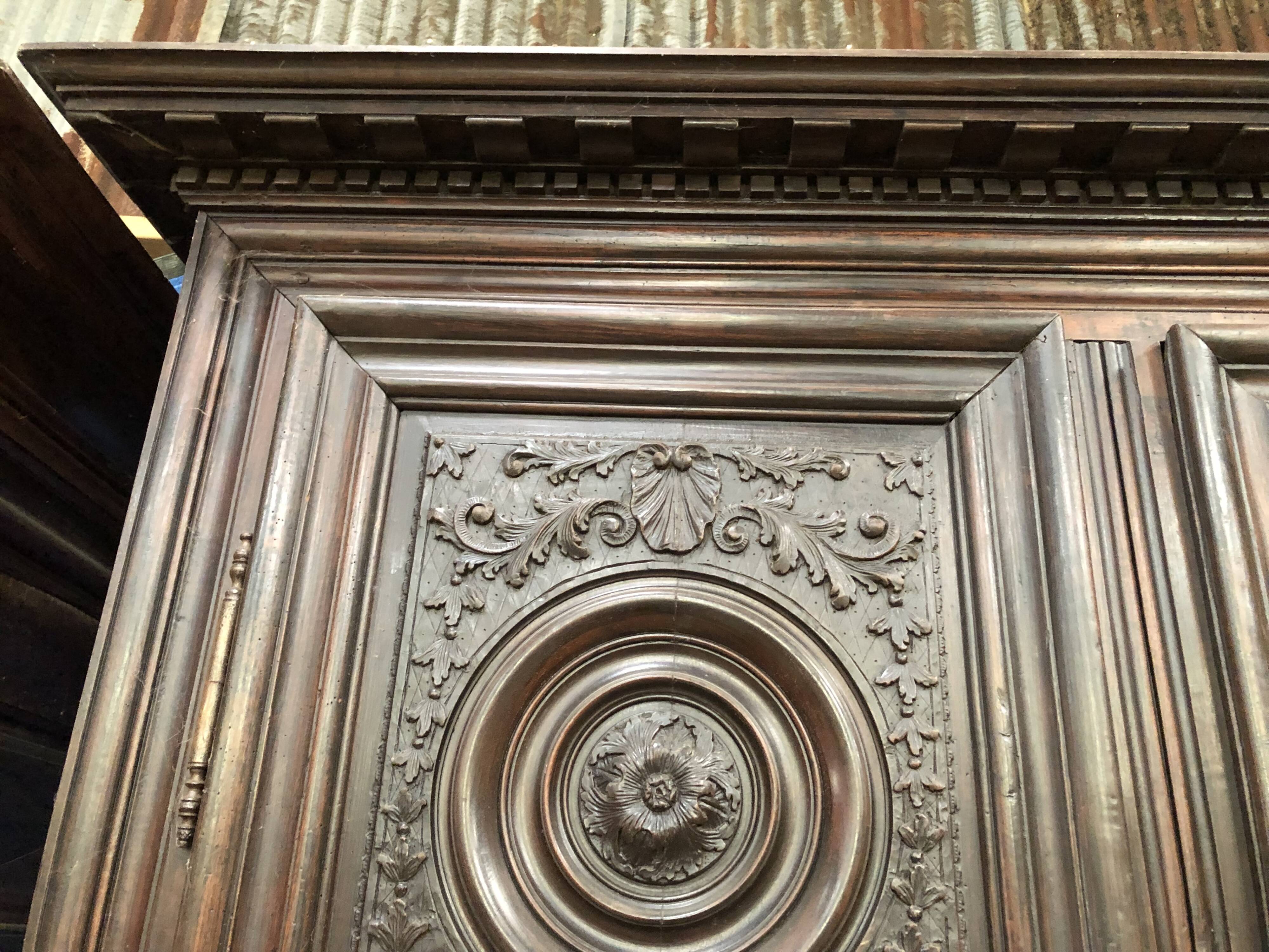 Antique Louis XIII armoire in solid walnut with carved doors