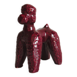 Chien en céramique émaillée rouge.
