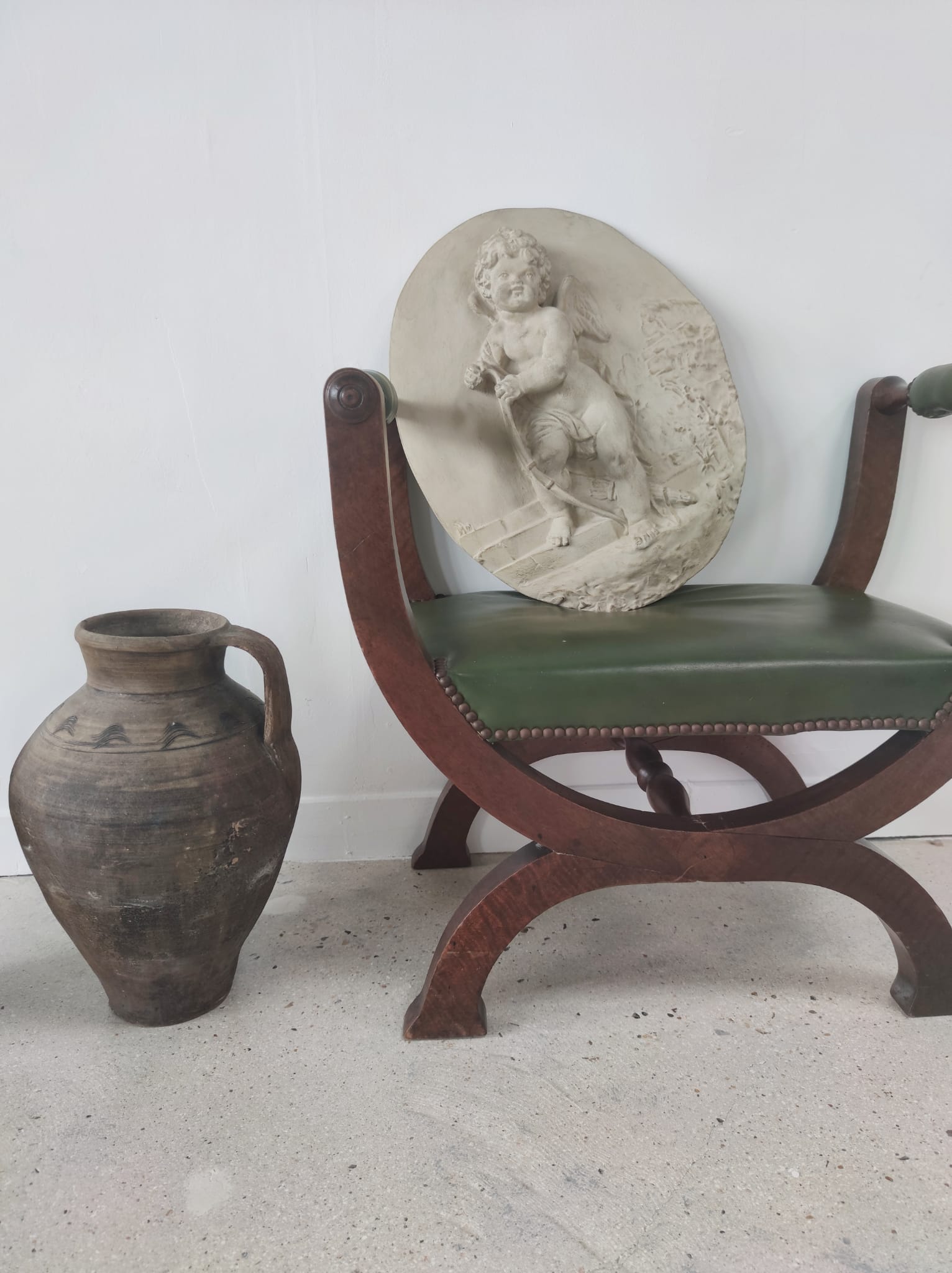 Green curule armchair